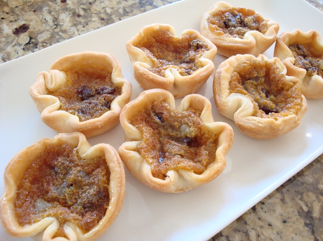 butter tarts on white plate